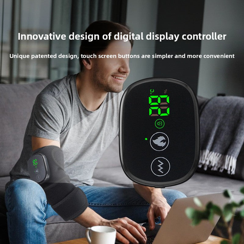 Heated massager worn on the elbow while working at a laptop
